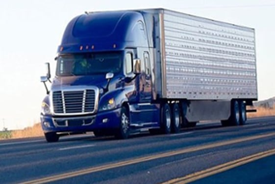 Semi truck driving down highway